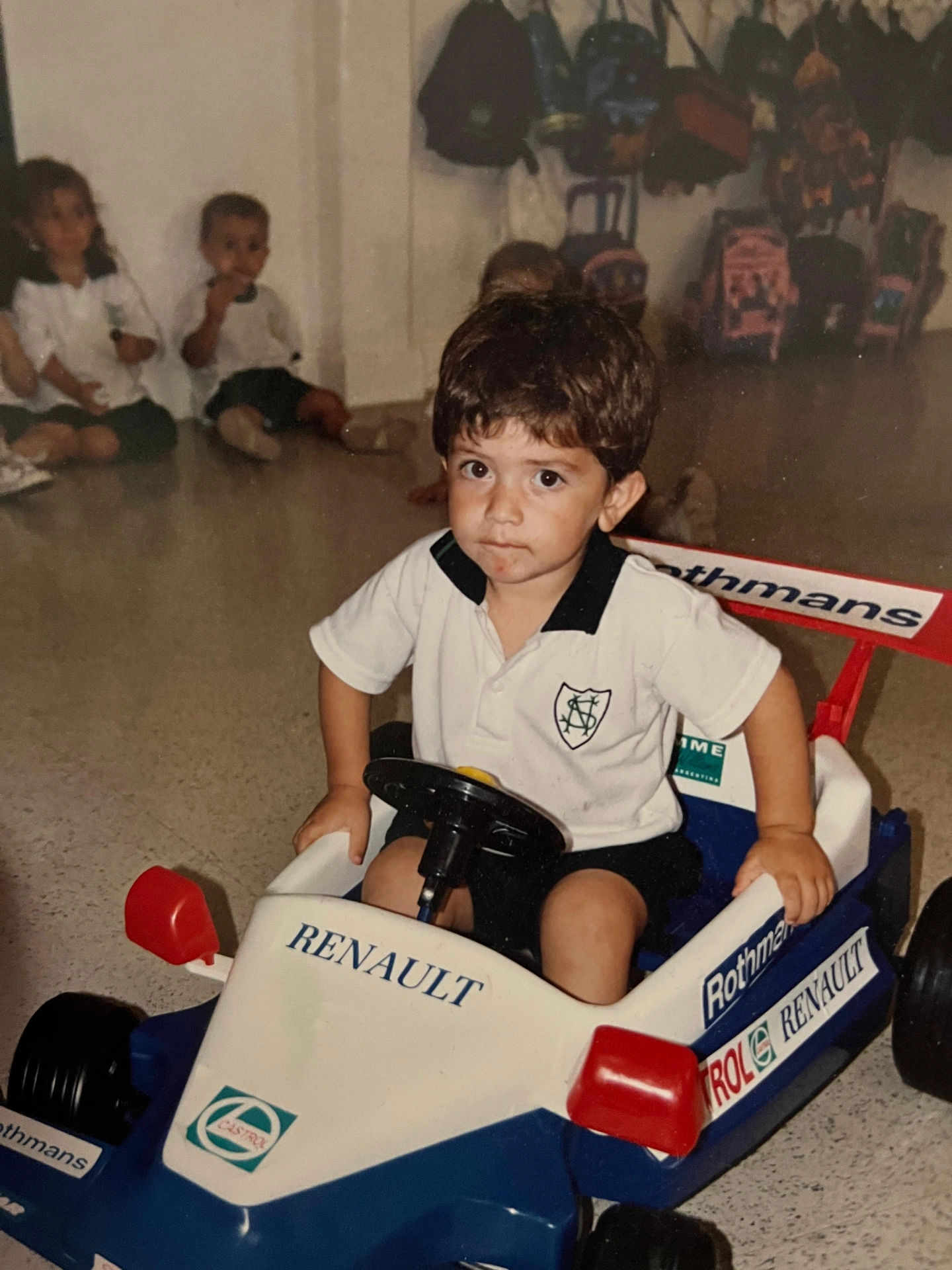 Facundo as a toddler at the wheel of a toy Renault F1 car