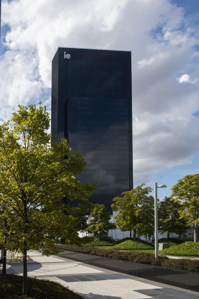 The IE Tower above the trees of the campus park